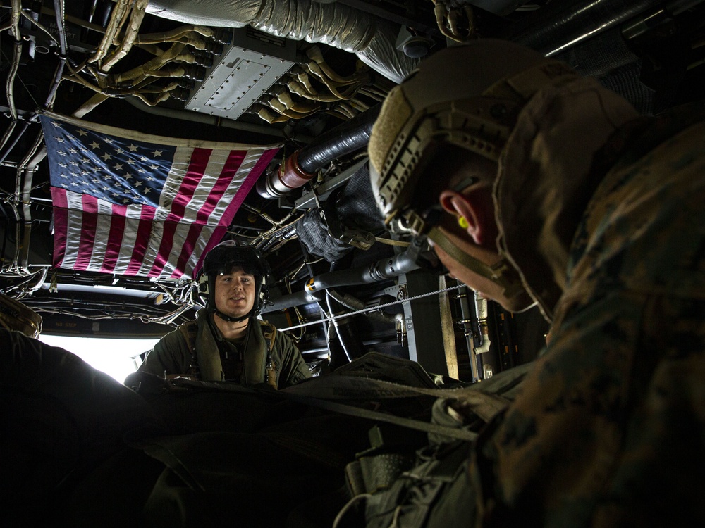 Riggers and Recon Marines jump over Ie Shima