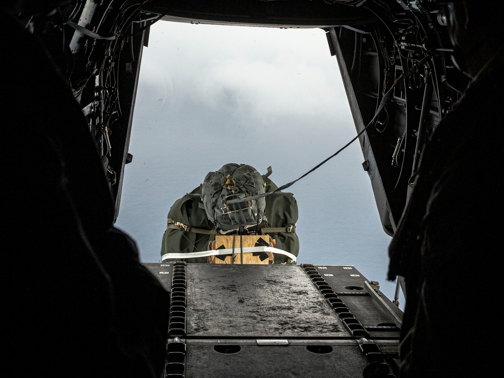 Riggers and Recon Marines jump over Ie Shima