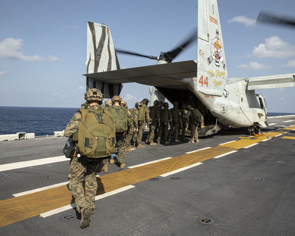 Riggers and Recon Marines jump over Ie Shima
