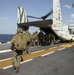 Riggers and Recon Marines jump over Ie Shima