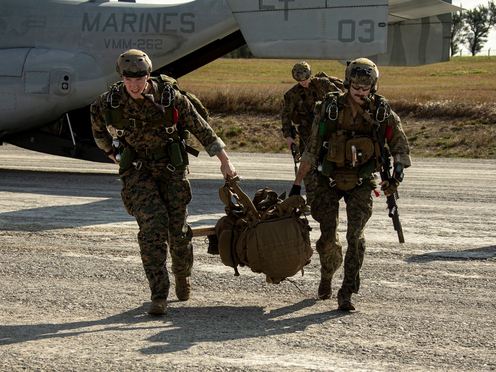 Riggers and Recon Marines jump over Ie Shima