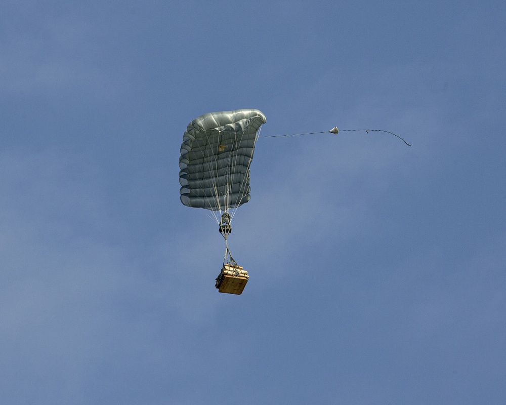 Riggers and Recon Marines jump over Ie Shima