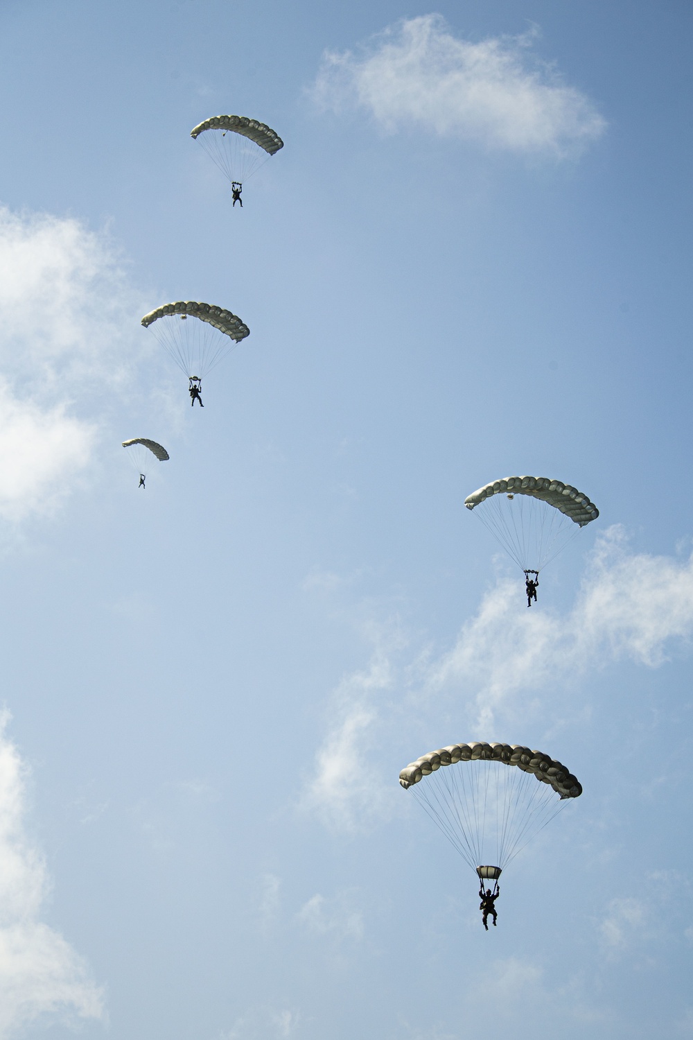 Riggers and Recon Marines jump over Ie Shima