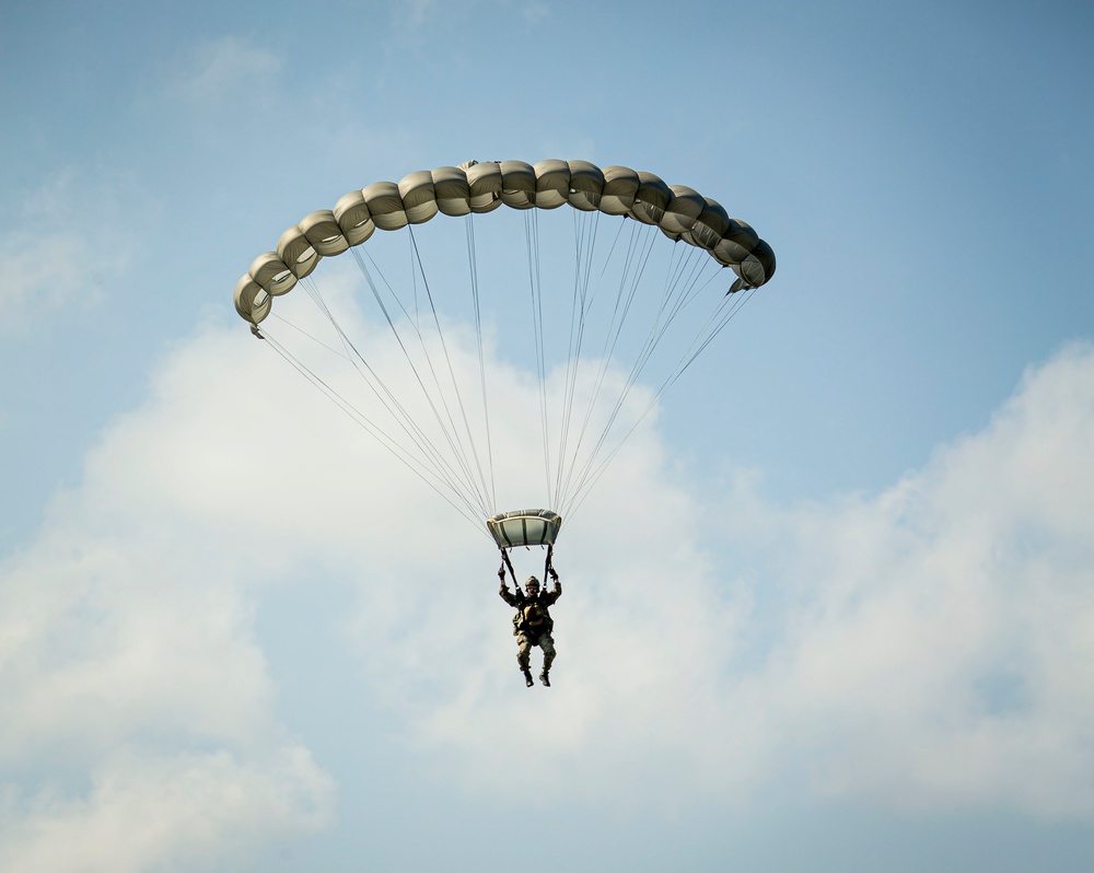 Riggers and Recon Marines jump over Ie Shima