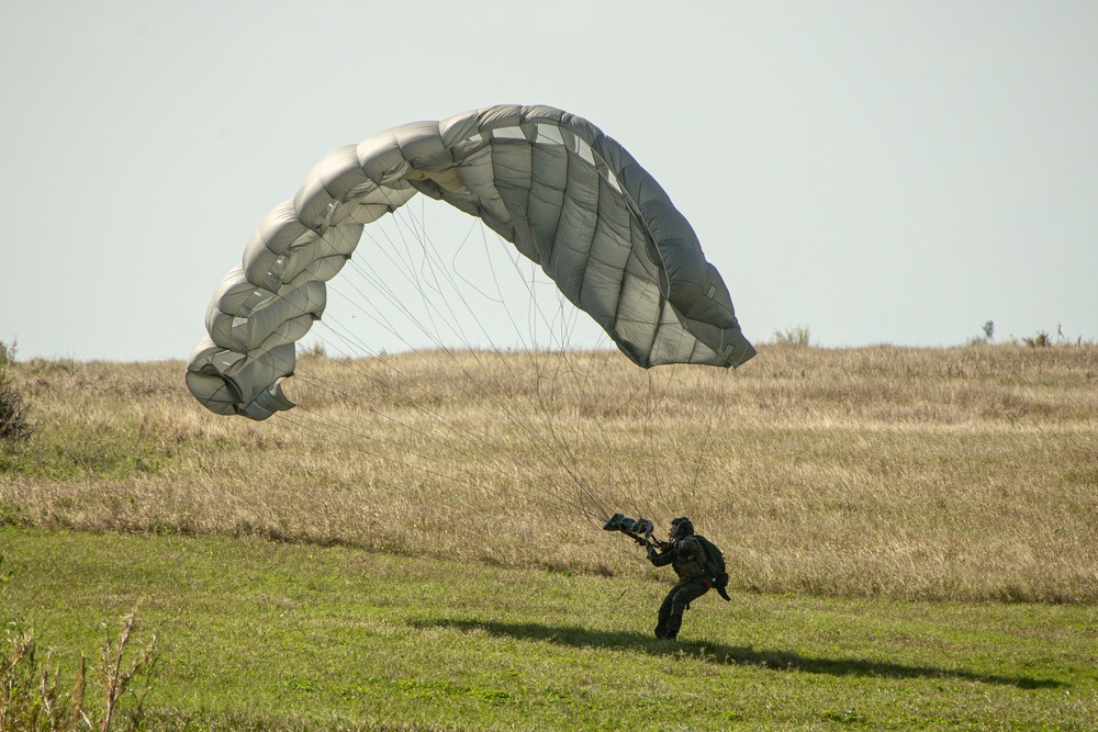 Riggers and Recon Marines jump over Ie Shima