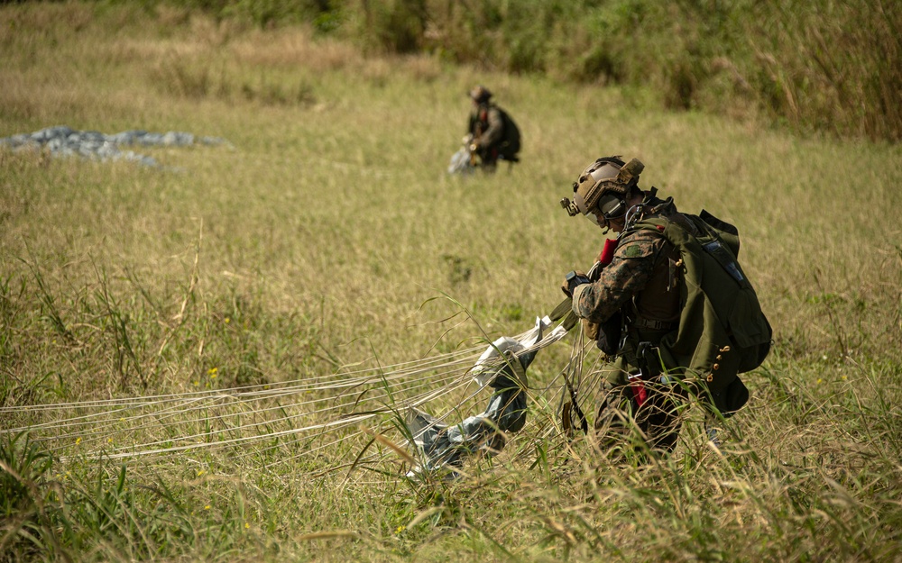 Riggers and Recon Marines jump over Ie Shima