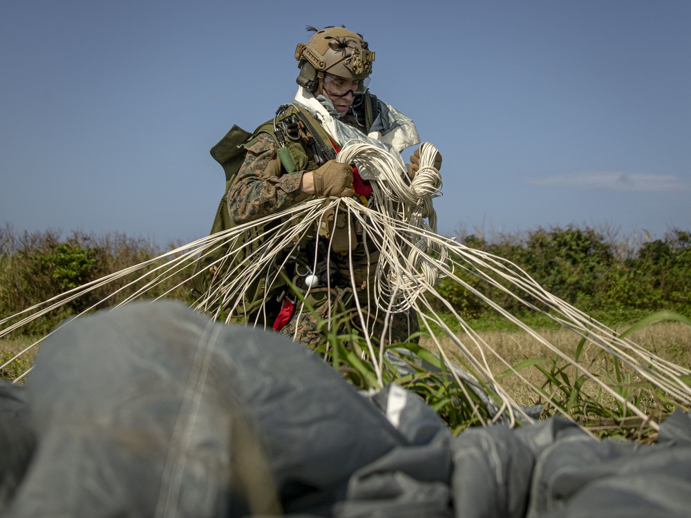 Riggers and Recon Marines jump over Ie Shima