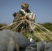 Riggers and Recon Marines jump over Ie Shima