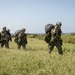 Riggers and Recon Marines jump over Ie Shima
