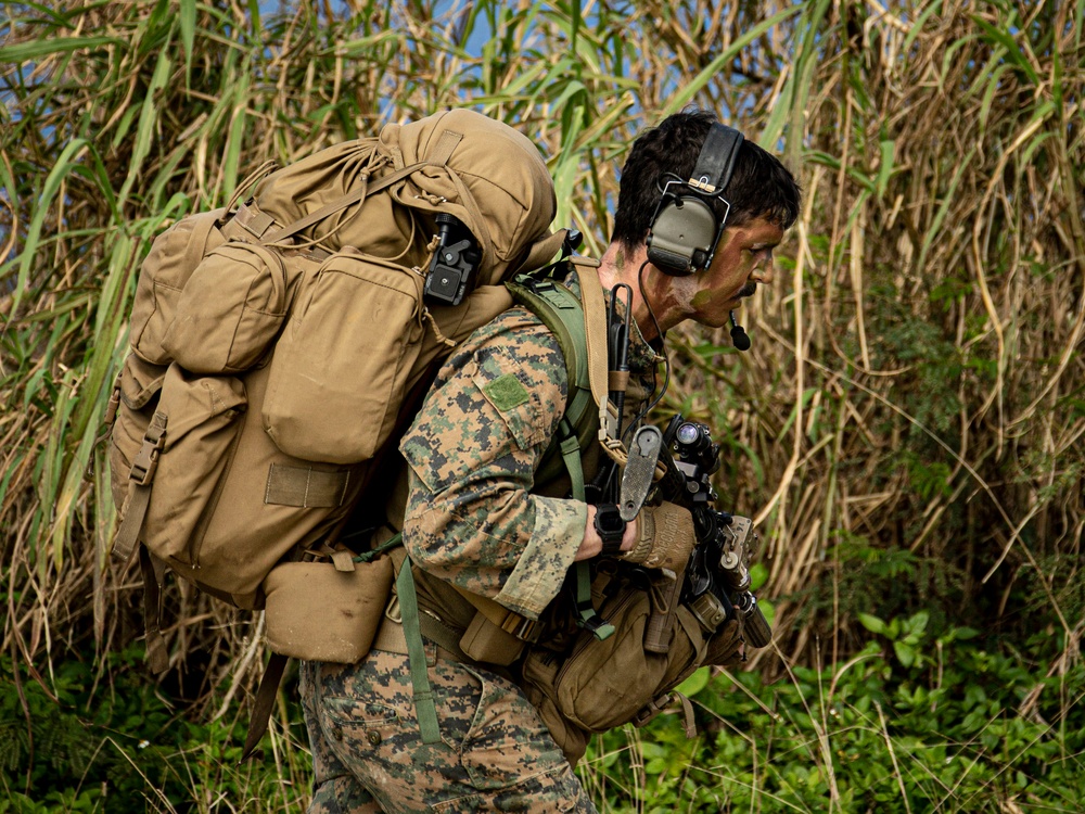 Riggers and Recon Marines jump over Ie Shima