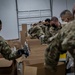 Washington National Guard soldier package and distribute food to local communities