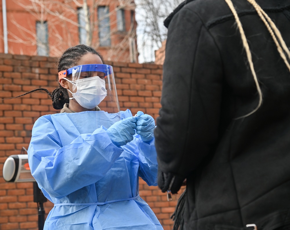 Members of the Maryland National Guard assists residents with COVID-19 self testing in Baltimore Maryland.
