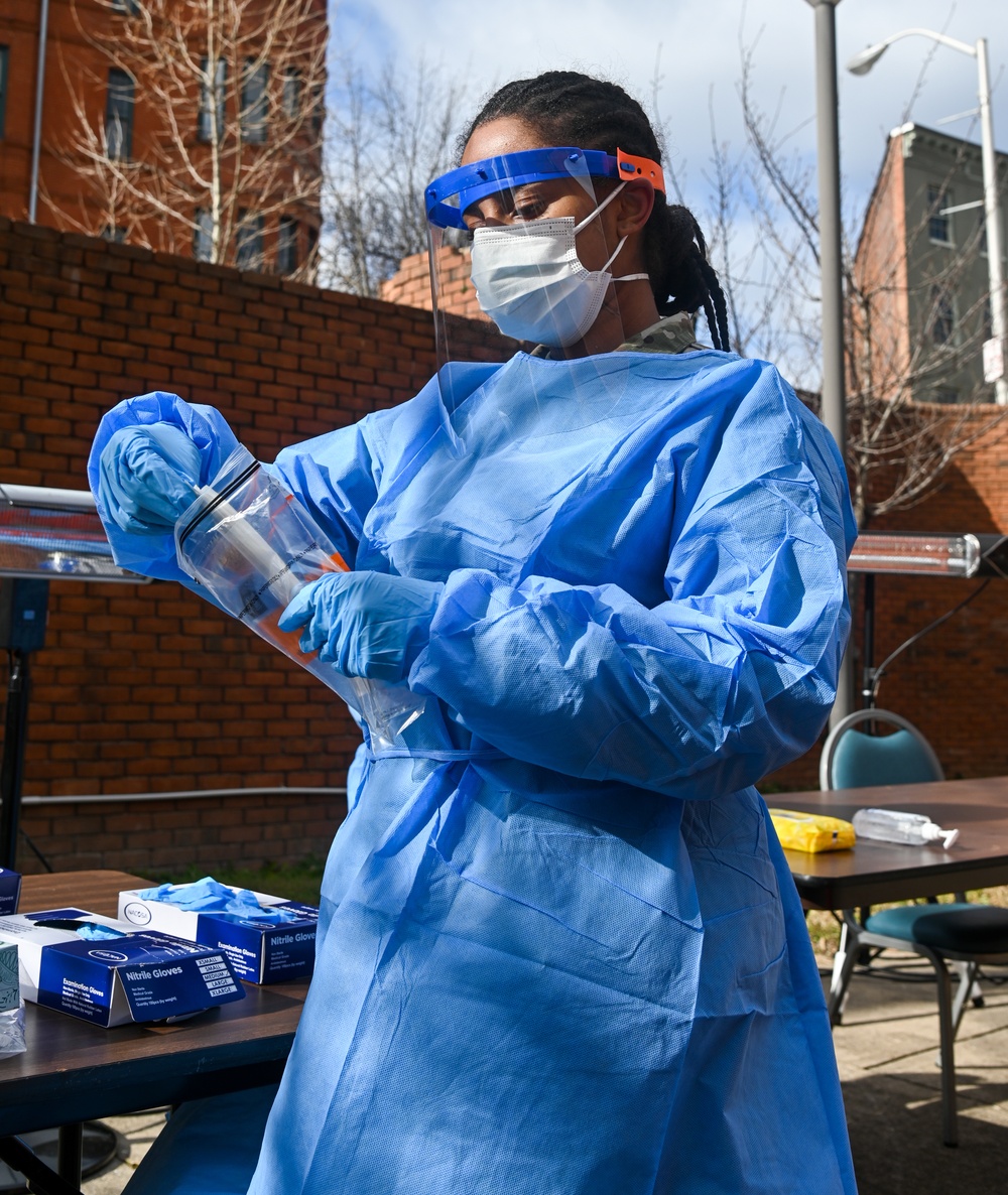 Members of the Maryland National Guard assists residents with COVID-19 self testing in Baltimore Maryland.