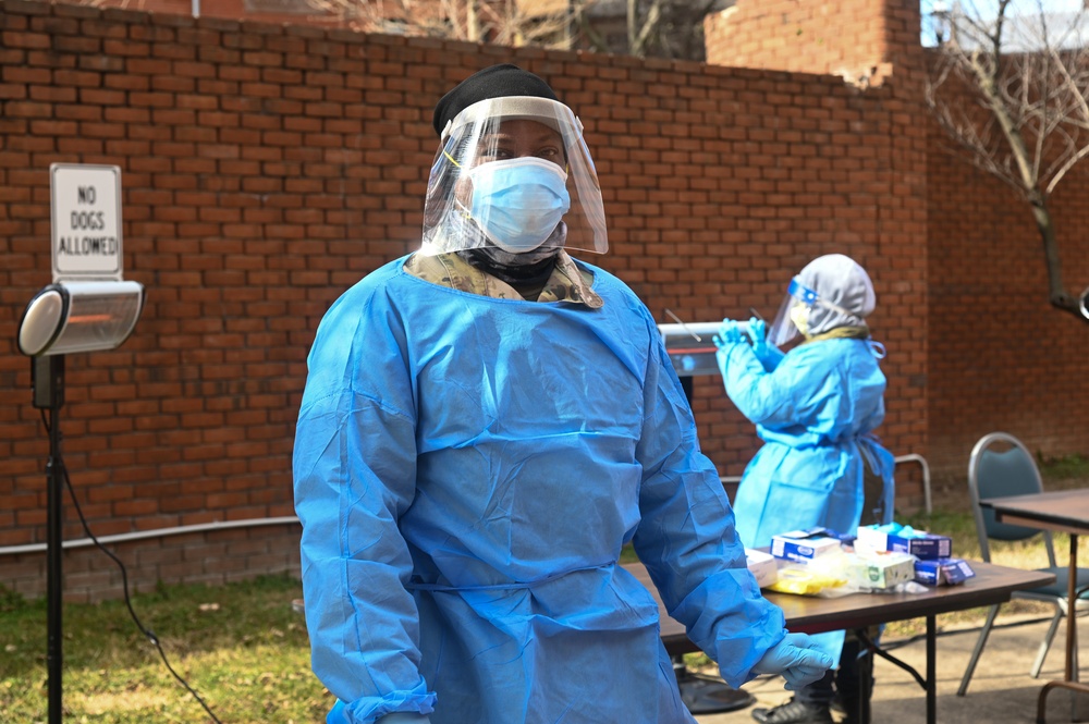 Members of the Maryland National Guard assists residents with COVID-19 self testing in Baltimore Maryland.