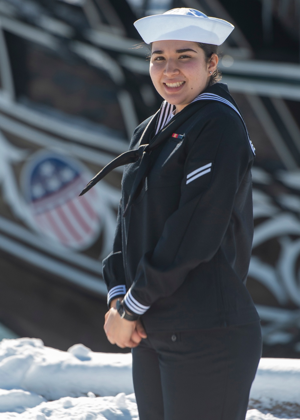 SN Nicole Gonzalez poses for a photo in front of USS Constitution