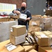 Material Examiner and Identifier Michael Seeger opens boxes of used property
