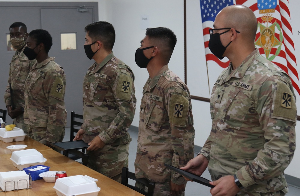 Soldiers from Bravo Battery, 5th Battalion, 52nd Artillery Regiment, present commemorative picture to Task Force Spartan Leadership