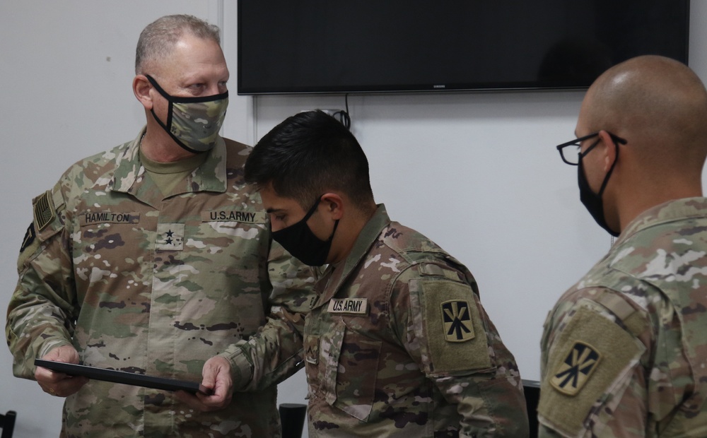 Soldiers from Bravo Battery, 5th Battalion, 52nd Artillery Regiment, present commemorative picture to Task Force Spartan Leadership