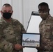 A Soldier from Bravo Battery, 5th Battalion, 52nd Artillery Regiment, present commemorative picture to Task Force Spartan Leadership