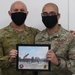 A Soldier from Bravo Battery, 5th Battalion, 52nd Artillery Regiment, present commemorative picture to USARCENT leadership