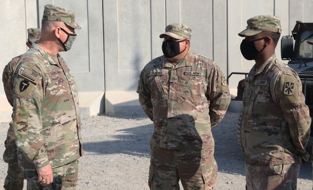 Soldier from 5-52nd ADA receives coin from TFS commander