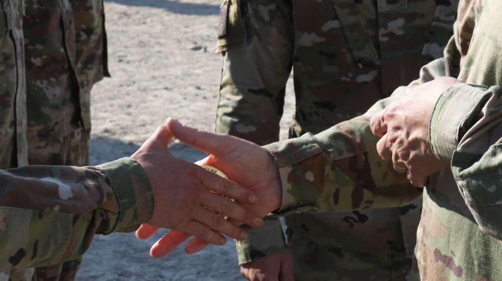 Soldier from 5-52nd ADA receives coin from TFS commander