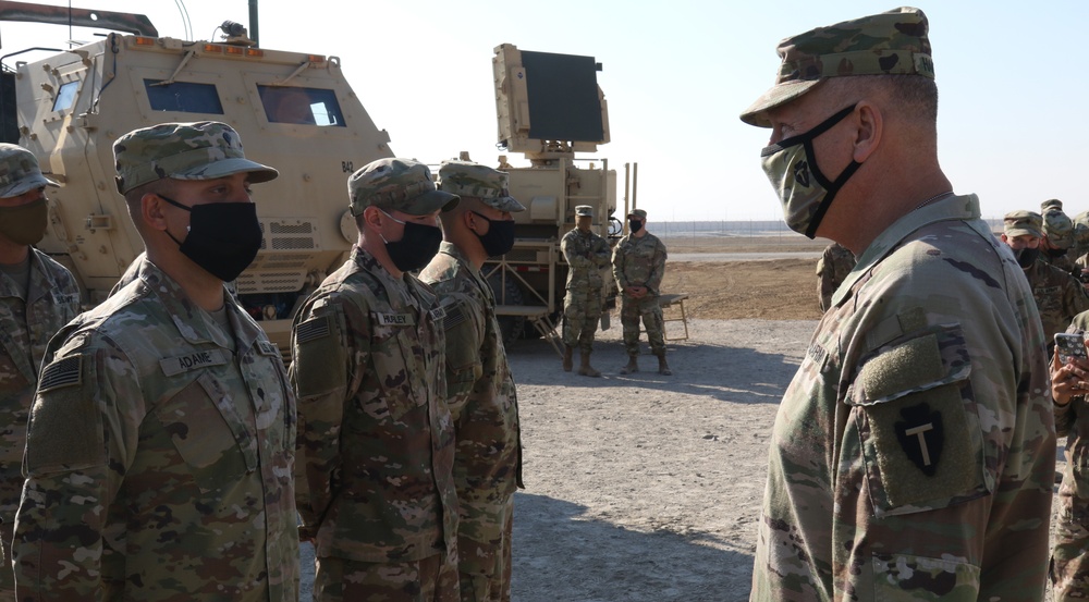 Soldier from 5-52nd ADA receives coin from TFS commander