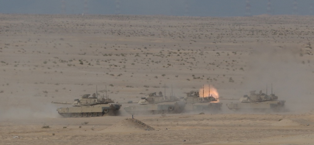 U.S. Army M1 Abrams tanks from 1st Battalion, 6th Infantry Regiment, 2nd Brigade Combat Team, 1st Armored Division, launch rounds down range during a live-fire exercise