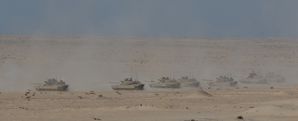 U.S. Army M1 Abrams tanks from 1st Battalion, 6th Infantry Regiment, 2nd Brigade Combat Team, 1st Armored Division, launch rounds down range during a live-fire exercise