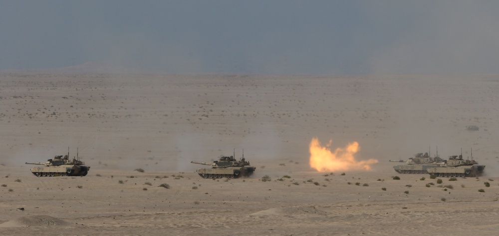 U.S. Army M1 Abrams tanks from 1st Battalion, 6th Infantry Regiment, 2nd Brigade Combat Team, 1st Armored Division, launch rounds down range during a live-fire exercise