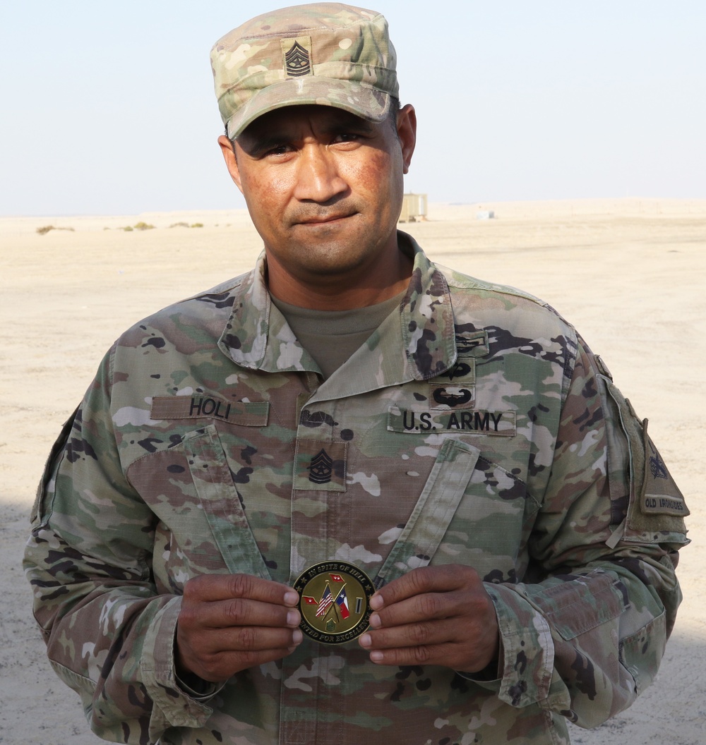 Sgt. Maj. Holi Holi, operations sergeant major for 1st Bn., 6th Inf. Reg., poses with Task Force Spartan challenge coin