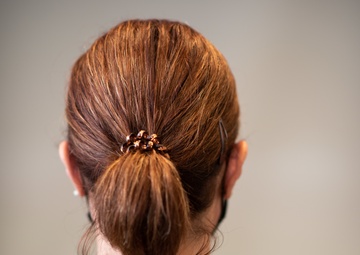 Photo of 1st Lt. Shelley Warren displaying the new hairstyle allowed for Air Force women