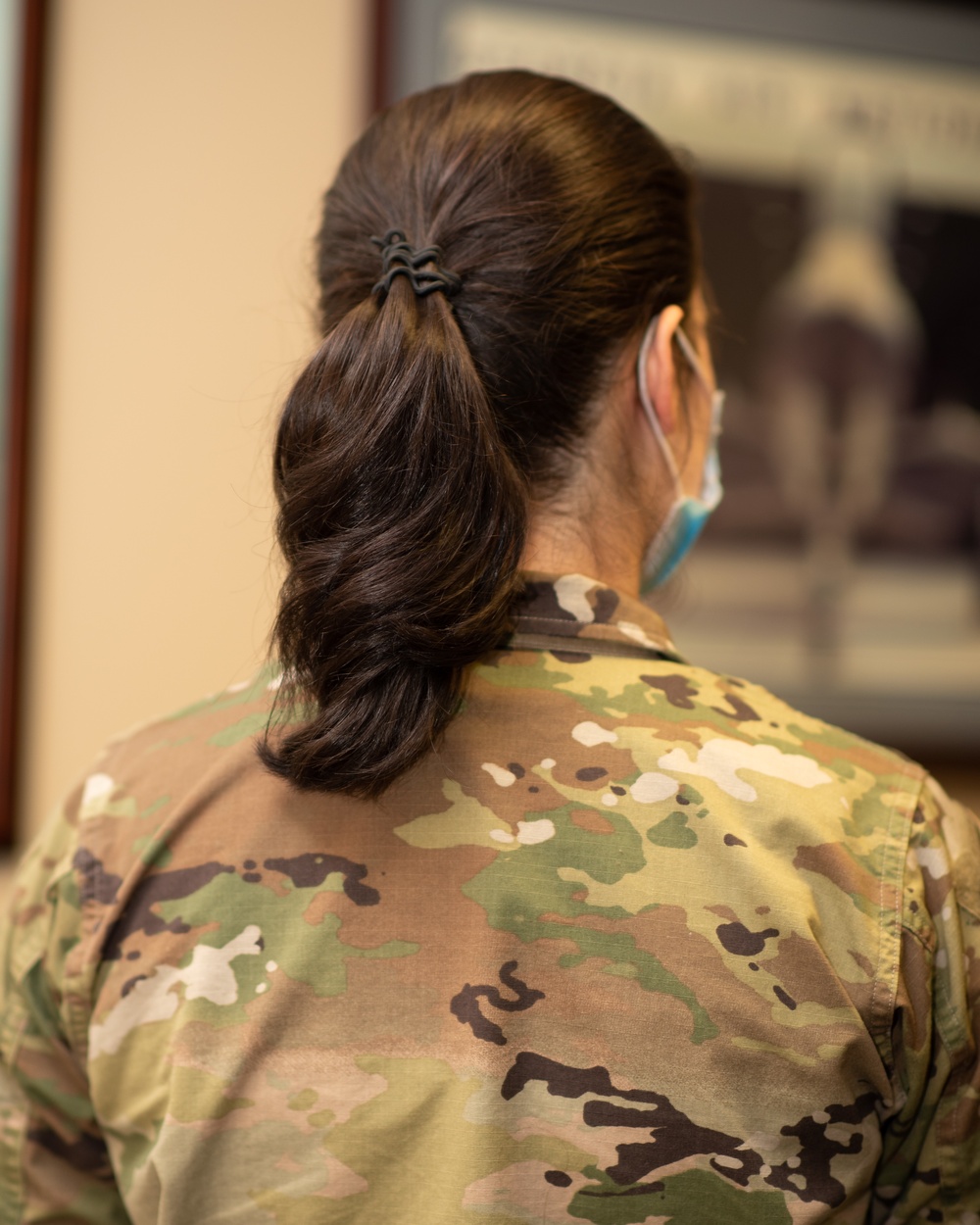 Photo of Tech. Sgt. Cher Schwein displaying the new hairstyle allowed for Air Force women