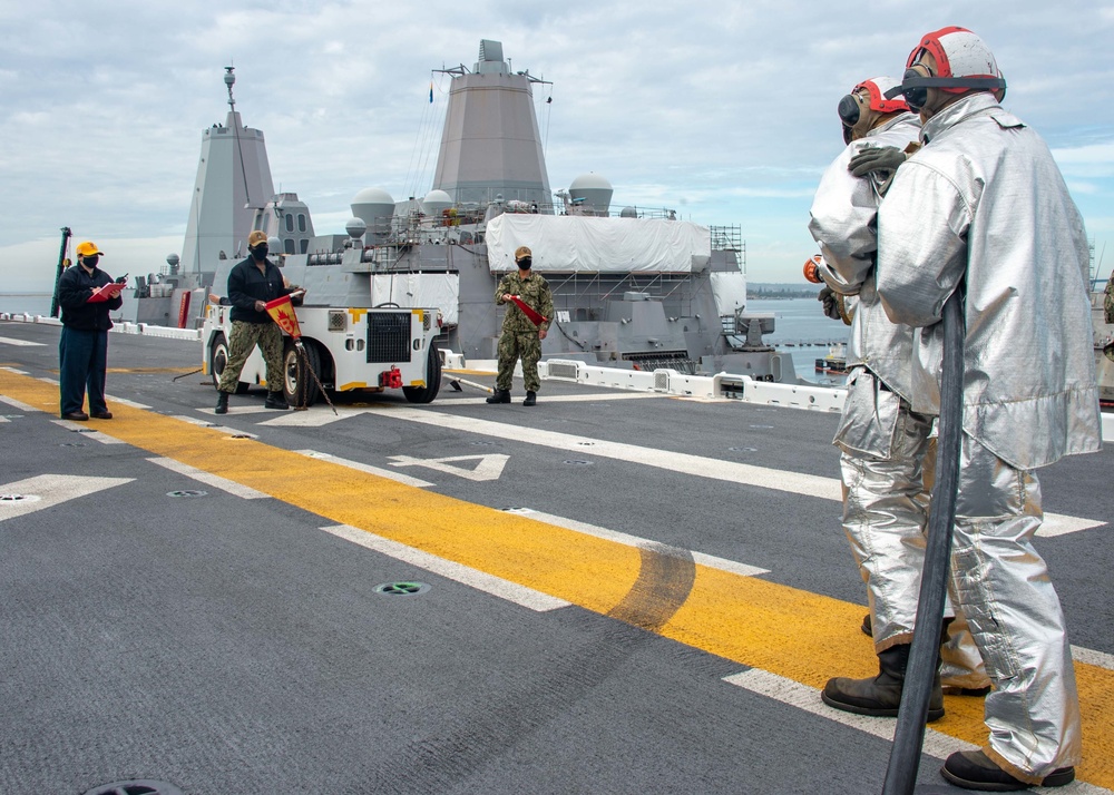 Sailors participate in a flight deck fire drill aboard Essex