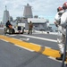 Sailors participate in a flight deck fire drill aboard Essex