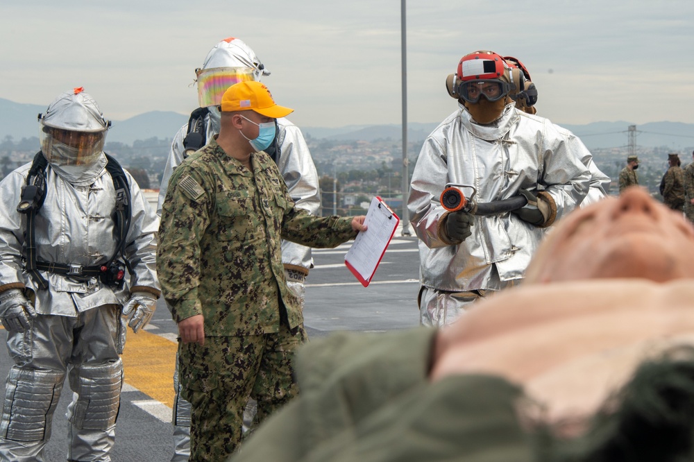 Sailors participate in a flight deck fire drill aboard Essex