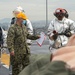 Sailors participate in a flight deck fire drill aboard Essex