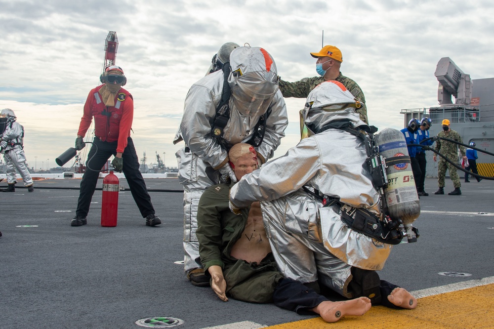 Sailors participate in a flight deck fire drill aboard Essex