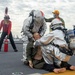 Sailors participate in a flight deck fire drill aboard Essex