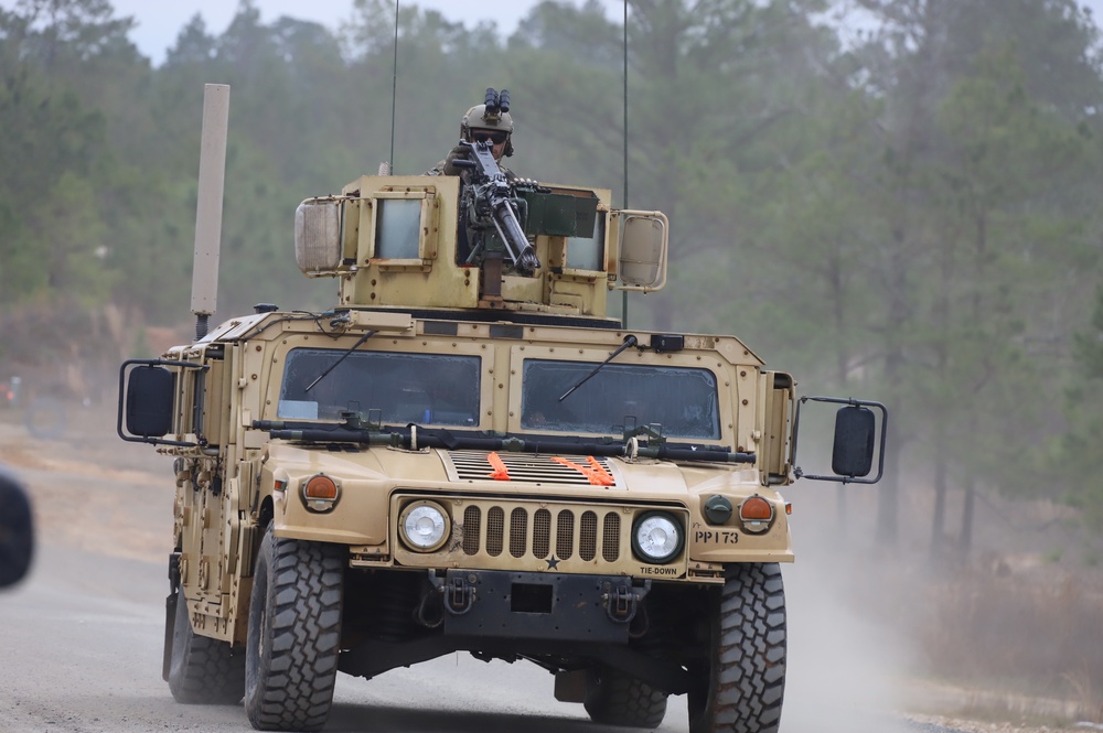A 3-82nd Gunner on Humvee on dusty road at RTN 21-04 at JRTC.