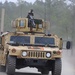 A 3-82nd Gunner on Humvee on dusty road at RTN 21-04 at JRTC.