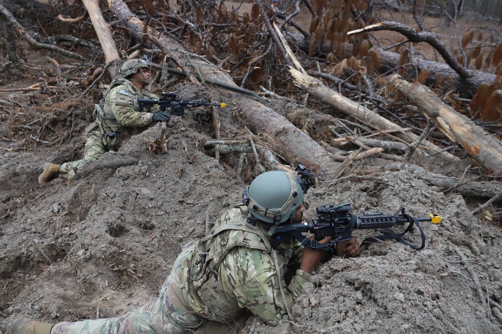 Two 3-82nd Soldiers, behind embankment pull security during JRTC RTN 21-04