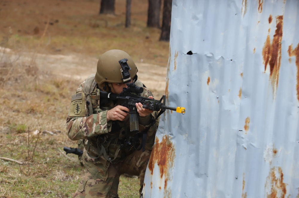 3-82nd Soldier crouched at edge of building with weapon engaging with G-Man