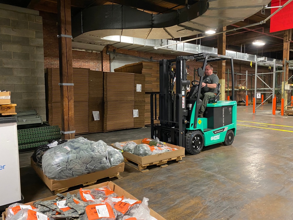 Material Examiner and Identifier Greg Reigle moves pallets of excess DOD goods