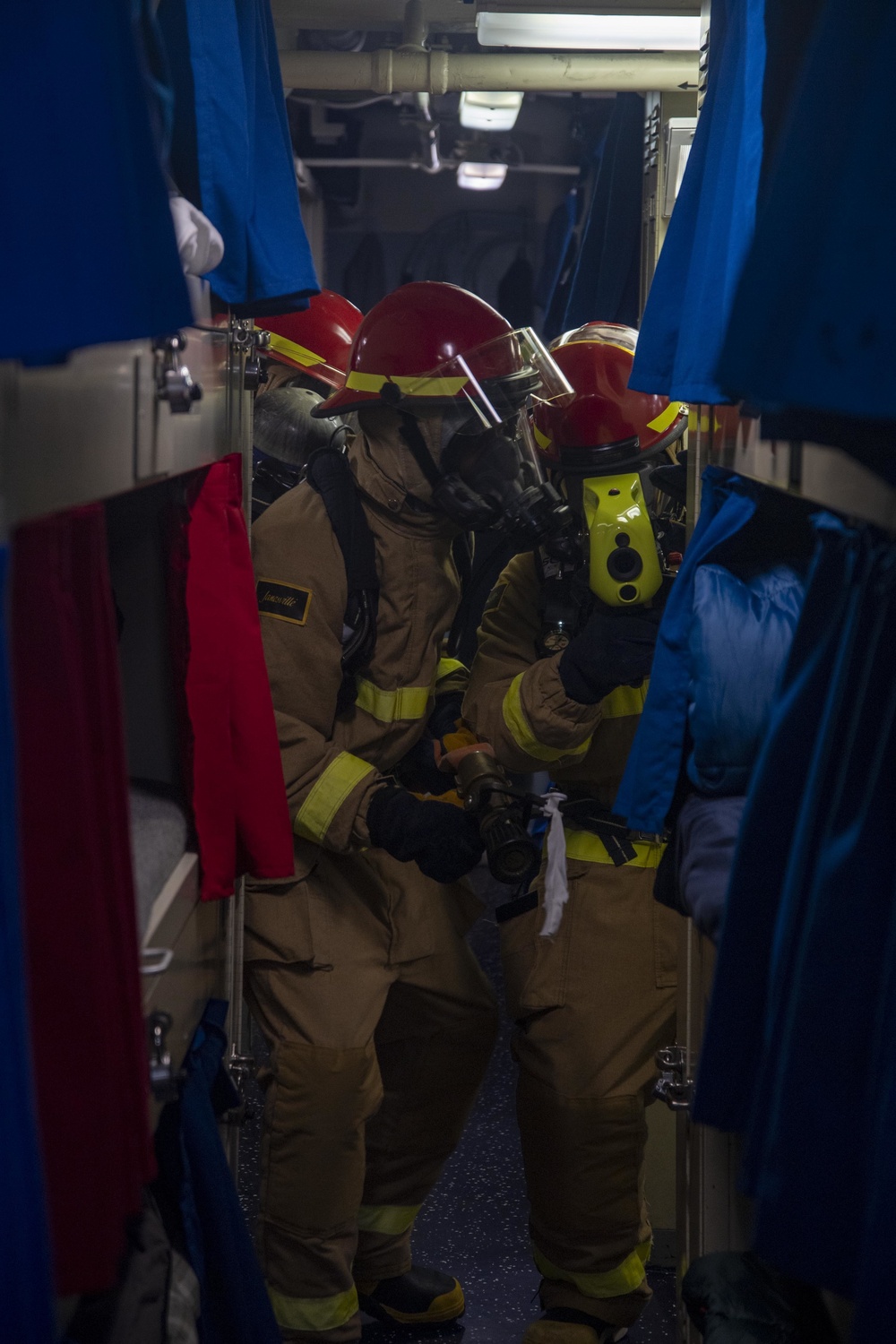 USS America (LHA 6) Sailors respond to simulated shipboard casualties during a general quarters drill.