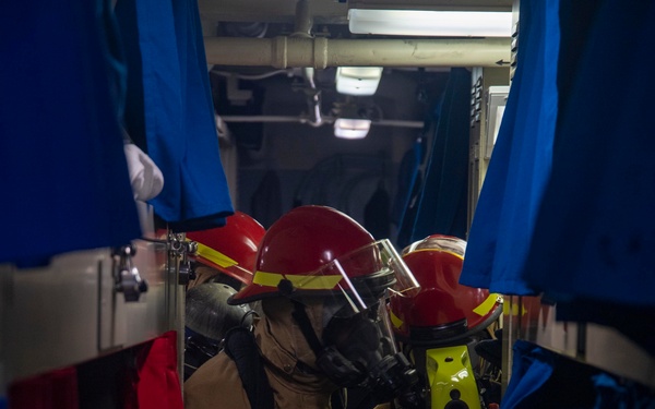 USS America (LHA 6) Sailors respond to simulated shipboard casualties during a general quarters drill.
