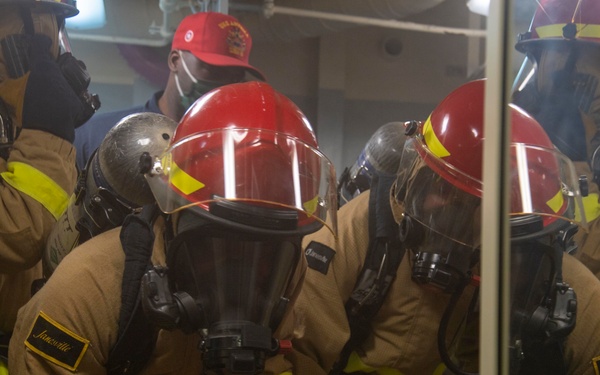USS America (LHA 6) Sailors respond to simulated shipboard casualties during a general quarters drill.