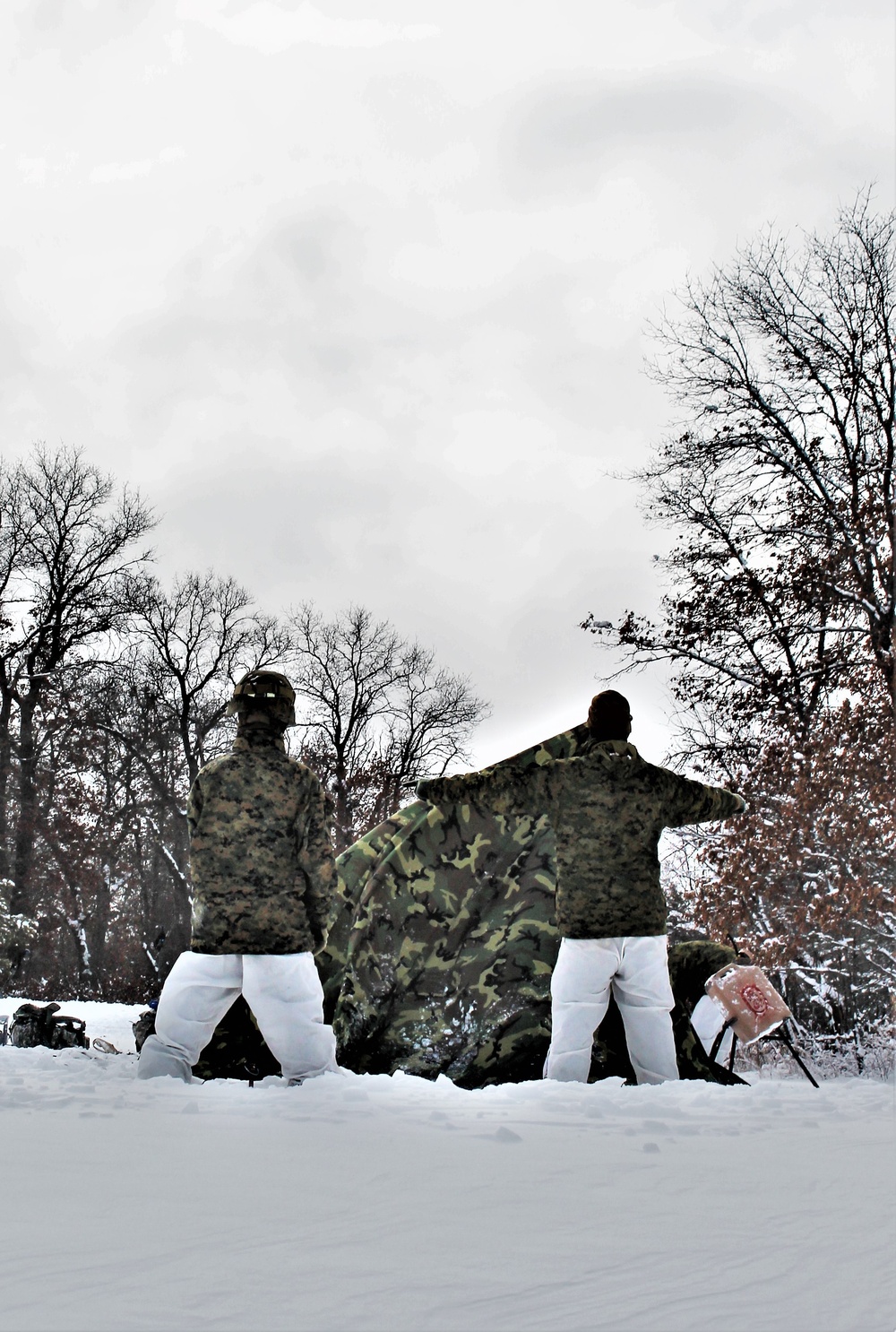 Fort McCoy CWOC class 21-03 students raise Artic tents during training scenario