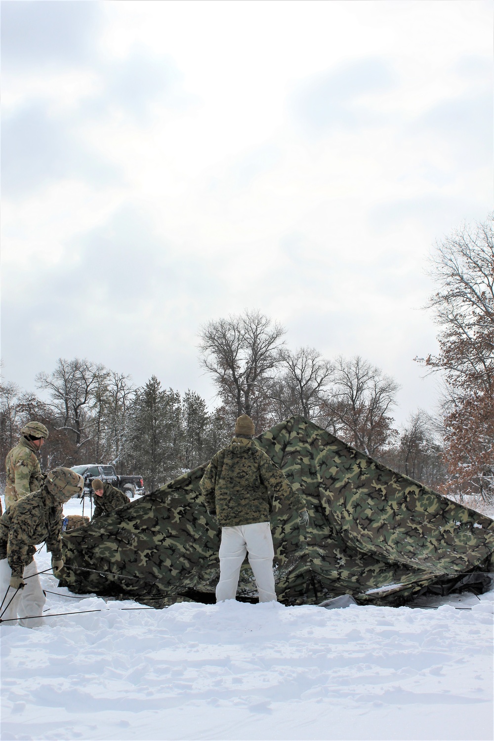 Fort McCoy CWOC class 21-03 students raise Artic tents during training scenario
