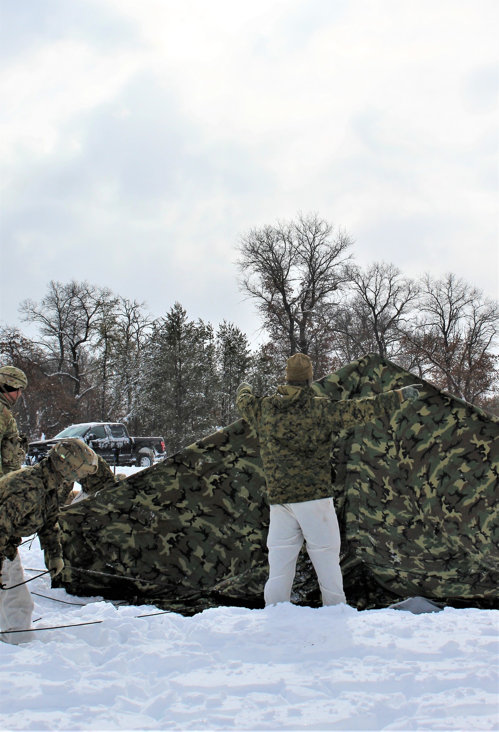 Fort McCoy CWOC class 21-03 students raise Artic tents during training scenario